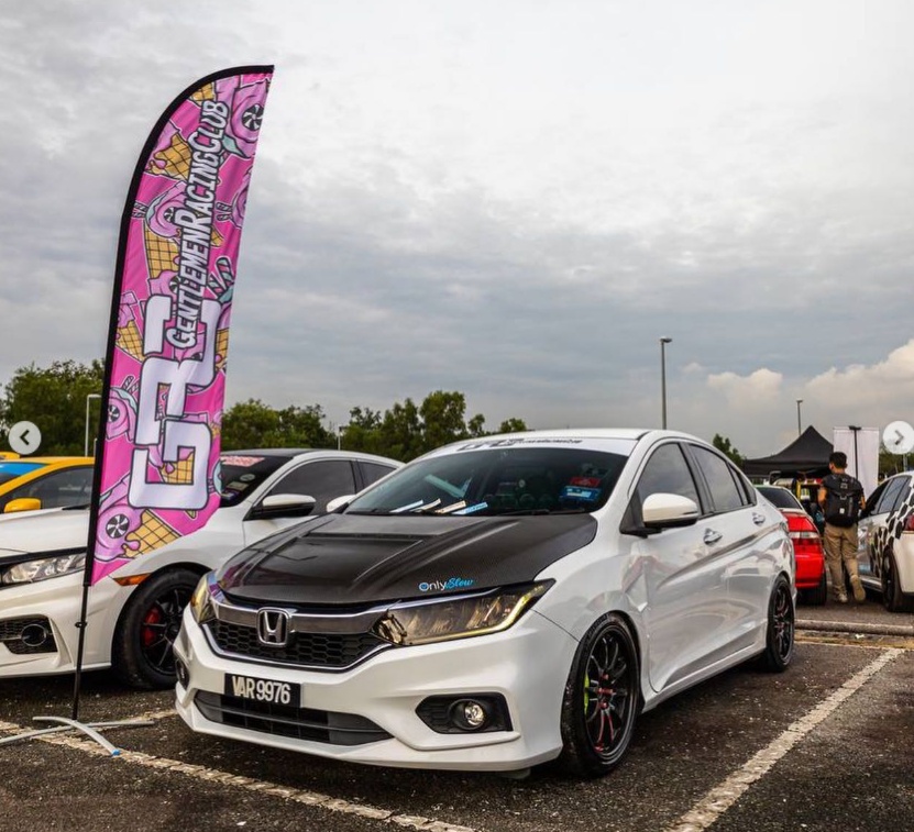 Fabric flag stand beside car for automotive roadshow promotion in Malaysia